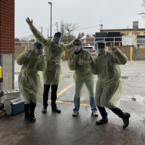 Staff at drive-thru immunization clinic pose for photo